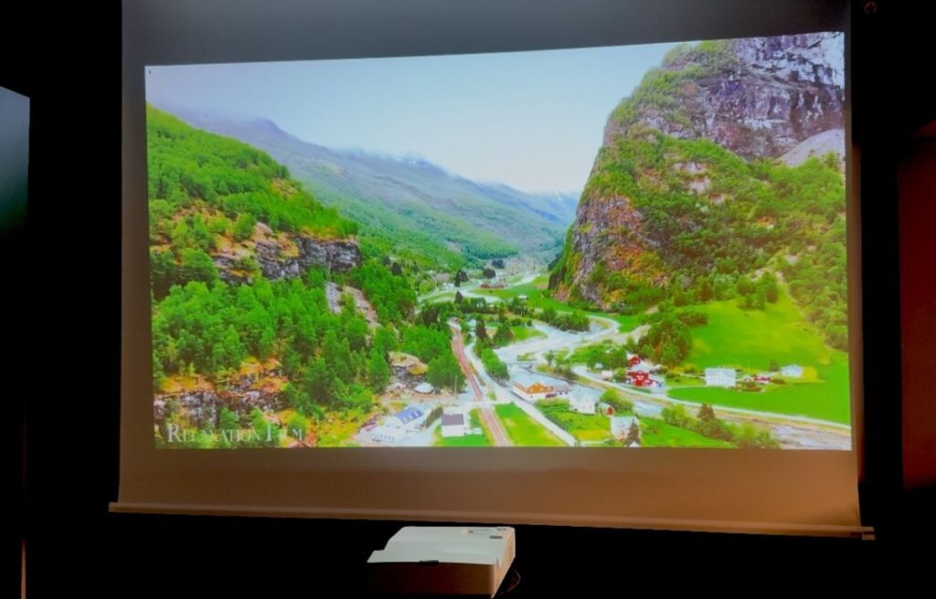 Projizierte Landschaft auf einer 400 cm Stiers Motorleinwand mit Kurzdistanzbeamer im Eingangsbereich eines Büros.